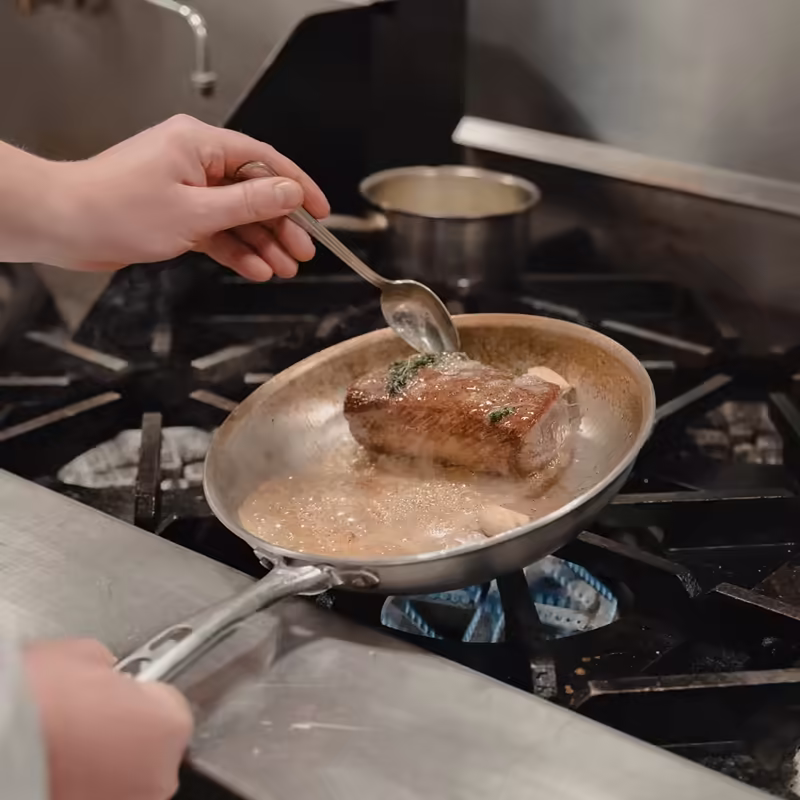Chef preparing a dish at a U.S. resort kitchen