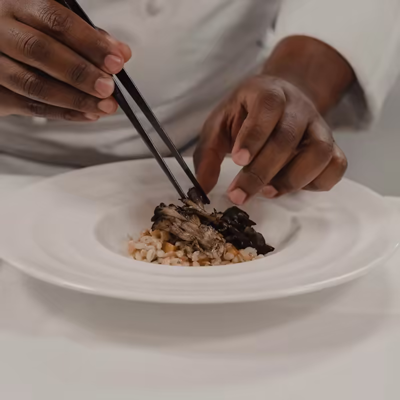 Chef plating fine dining at a resort restaurant